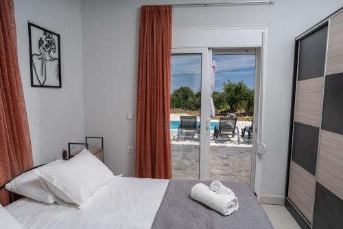 a bedroom with a bed and a view of a patio at Studios Maximo in Karavádhos