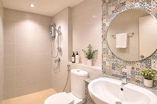 a bathroom with a toilet and a sink and a mirror at Urban Homie 40 in Langu