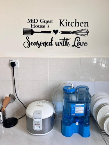 a kitchen preserved with love wall decal in a kitchen at MiD Guest House in Gambang