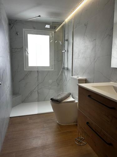 a bathroom with a shower and a tub and a sink at El Cotillo Mar Beach in El Cotillo