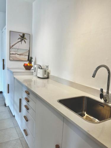 a kitchen with a sink and a counter top at Little Palm Studio in Cap Malheureux