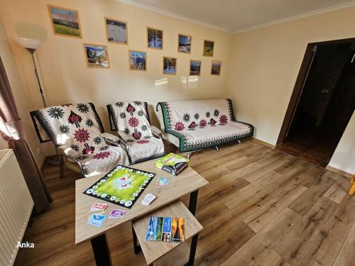 a living room with two couches and a coffee table at Zawoja Domek 1895 - Sauna i Bania in Zawoja