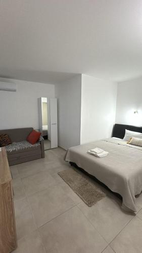 a bedroom with a large bed and a couch at Casa Verde in Boreti