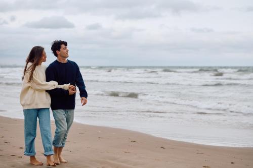 a man and a woman standing on the beach at Relax & Sea in Ostend