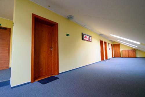 an empty hallway of an office with a door at Penzion Dyje in Hevlín