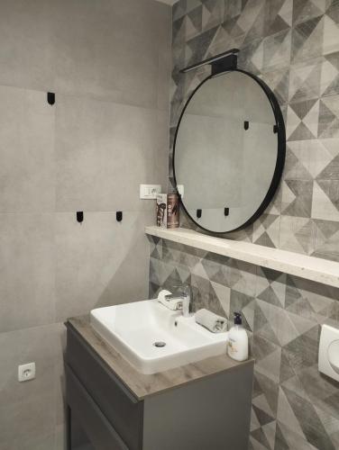 a bathroom with a sink and a mirror at Apartments Skorin in Lumbarda
