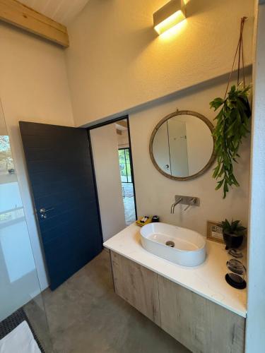 a bathroom with a sink and a mirror at The Sleep Studio in Kampersrus AH