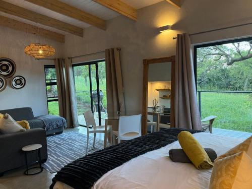 a bedroom with a large bed and a living room at The Sleep Studio in Kampersrus AH