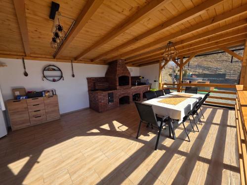 a dining room with a table and a fireplace at A Dream Colibita in Colibiţa