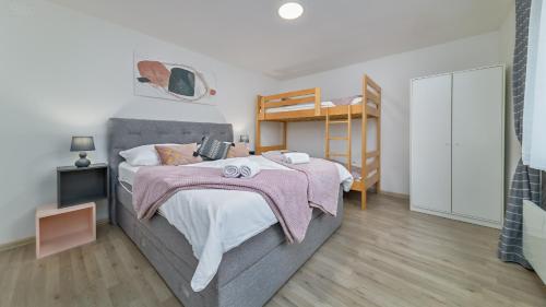 a bedroom with a bed and a bunk bed at Apartman Grey in Jastrebarsko