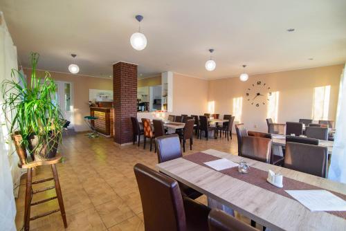 a restaurant with a dining room with tables and chairs at Penzion Dyje in Hevlín