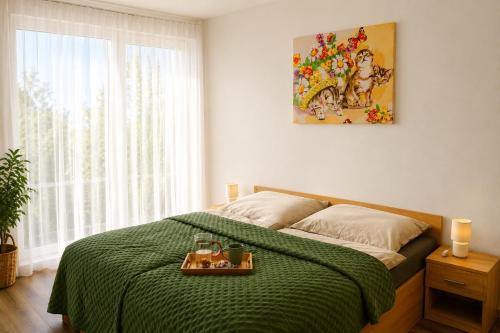 a bedroom with a bed with a tray of food on it at Na kopečku u lesa in Březová
