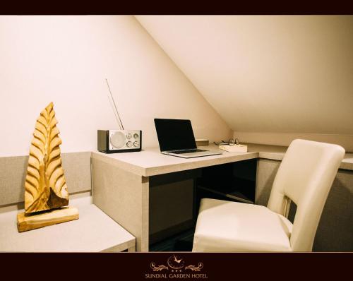 a room with a desk with a laptop and a chair at Sundial Boutique Hotel in Zagreb