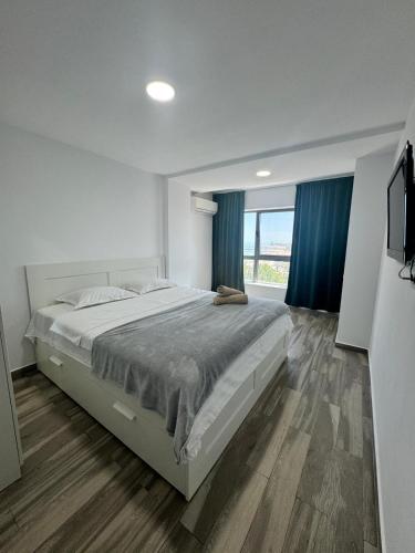 a bedroom with a large bed and a large window at Olimp sea view in Olimp
