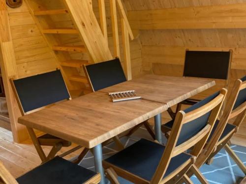 a wooden table and chairs in a room at Cabane spacieuse - 7 pers. - API-1-52-2440 in Meyrueis