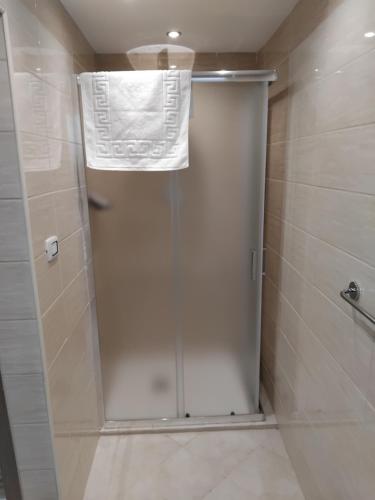 a shower stall with a white door in a bathroom at Papale AIRPORT HOUSE in CTA