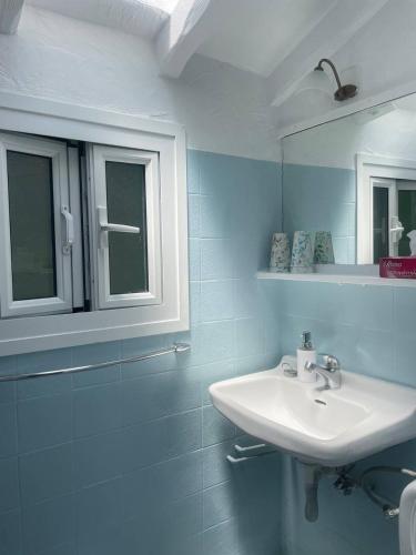 a bathroom with a sink and a mirror at Casa Lucia Green Cottage in Corfu