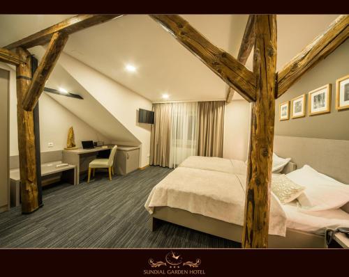 A bed or beds in a room at Sundial Boutique Hotel
