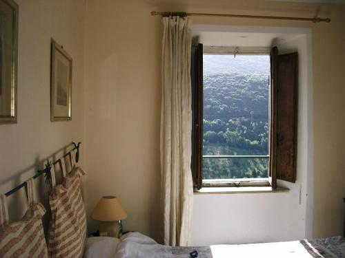 a bedroom with a bed and a window at La Torretta Historical Home in Casperia