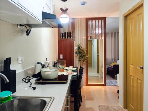 a kitchen with a sink and a counter top at WanderDesk Living-Studio Unit with Workstation in Piapi