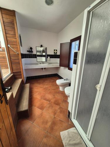 a bathroom with two toilets and a shower at Cuevas La Cocinillas in Graena