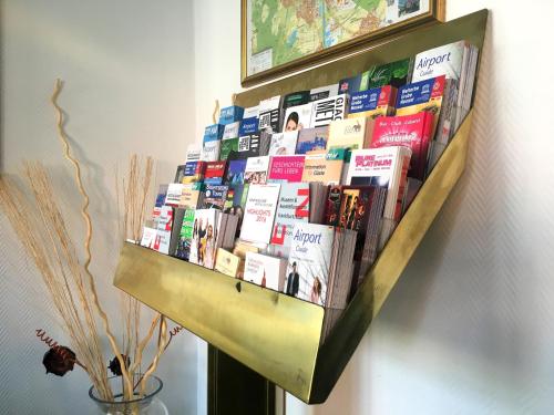 a book shelf filled with books on a wall at Turm Hotel Hanau in Hanau am Main