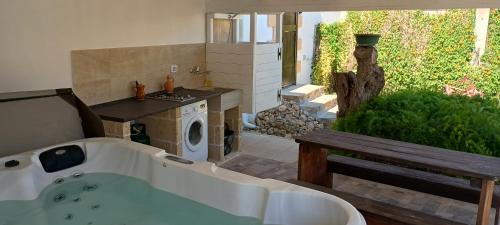 a bathroom with a bath tub and a sink at Chalet Gallipoli in Gallipoli