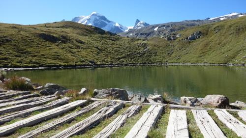 a body of water with mountains in the background at Hotel L'Etable in Les Crosets