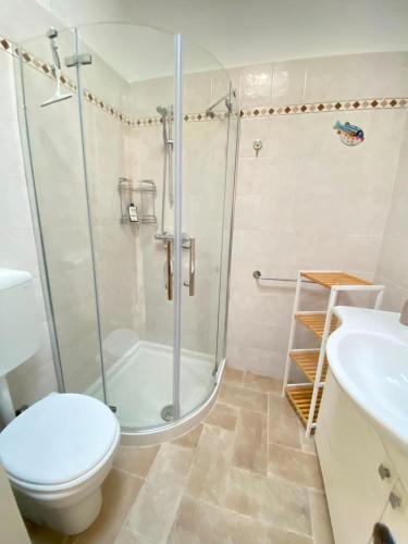 a bathroom with a shower and a toilet and a sink at La Casina di Perla in Viareggio