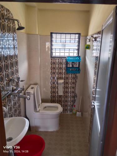 a small bathroom with a toilet and a sink at Buddhi Boutique in Pokhara