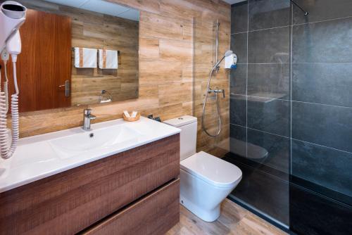 a bathroom with a sink and a toilet and a shower at Mercè in Pineda de Mar
