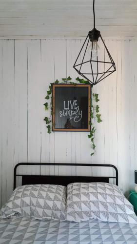 a bedroom with a bed and a sign on the wall at Casa Urgueira in Pendilhe