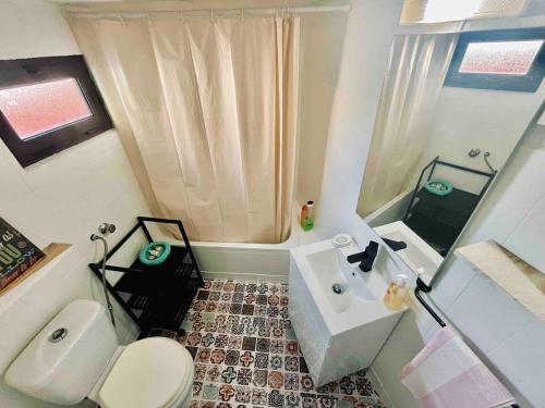 a small bathroom with a toilet and a sink at Casa Urgueira in Pendilhe