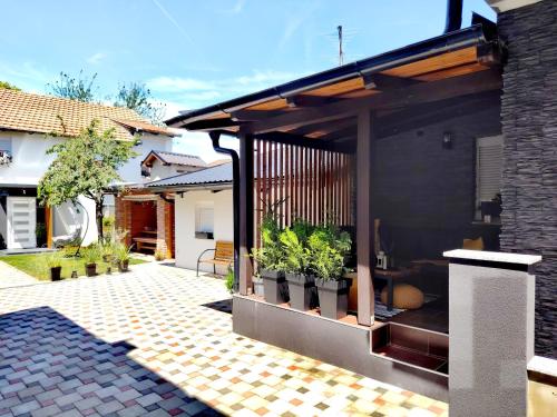 a house with a patio with plants on it at Apartman Pariz in Slavonski Brod