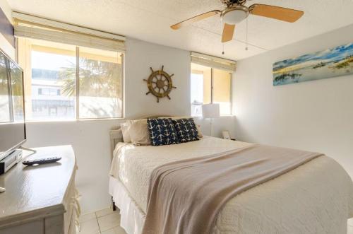 a bedroom with a bed and a clock on the wall at Sea Palm G in Fort Walton Beach