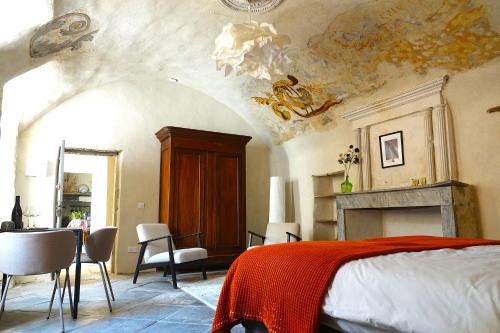 a bedroom with a bed and a fireplace at Ancienne eglise in Vallérargues