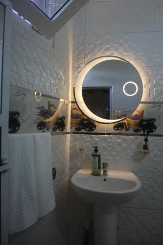 a bathroom with a sink and a mirror at Bab Akchour in Chefchaouen
