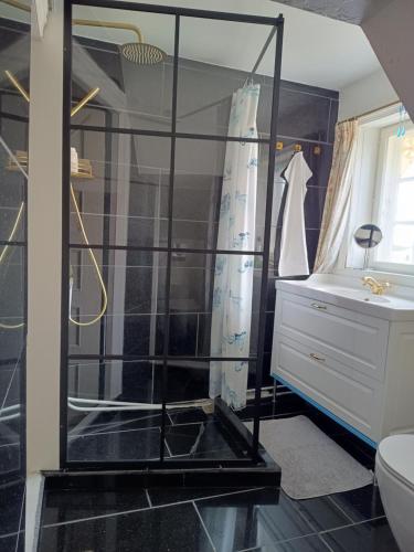 a bathroom with a shower and a sink at Aakirkeby Bed and Breakfast in Åkirkeby