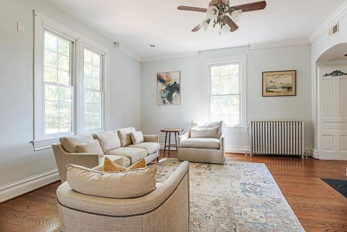 a living room with two couches and a ceiling fan at Clonmel Acres in Afton