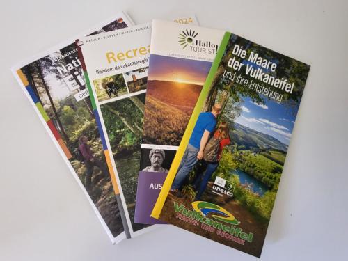a group of magazines on a table at Ferienwohnung Tutbach in Jünkerath