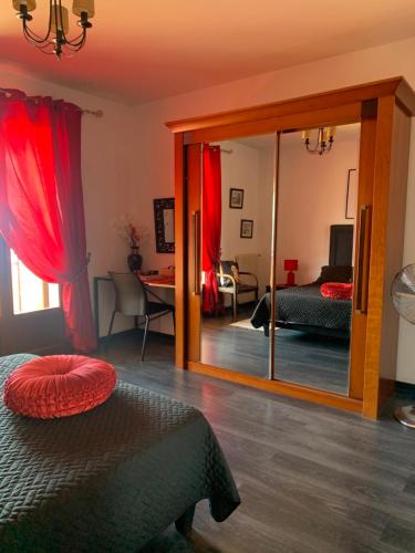 a bedroom with a mirror and a bed and a living room at Casa cesari in Ajaccio