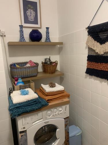 a laundry room with a washing machine and towels at Casa cesari in Ajaccio