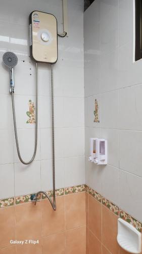 a shower in a bathroom with a toilet and a sink at Chaya village B - a shared pool & Jacuzi in Ko Lanta