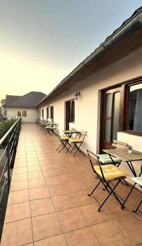 a patio with chairs and tables and a building at Casa Silvia in Costinesti