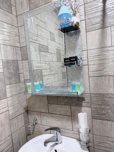 a bathroom with a sink and a mirror at Moss House in Sevan