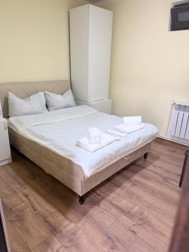 a bedroom with a bed with two towels on it at Moss House in Sevan