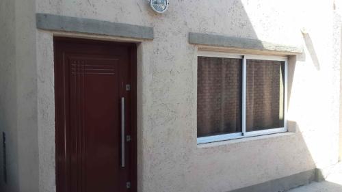 a door of a building with a window at Kaizen in Mendoza