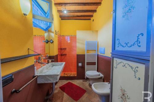 a bathroom with a sink and a toilet and a shower at Tuscan house, exclusive pool, private garden in Bagni di Lucca