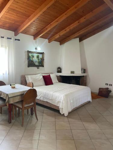 a bedroom with a large bed and a table at Diarla's Home in Fier