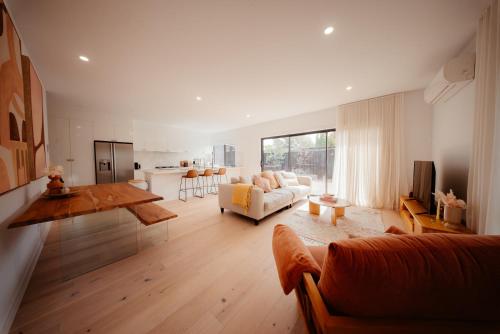 a living room with a couch and a table at Coastal on Clarke in Portarlington